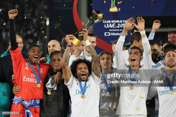 Marcelo of Real Madrid celebrates with the trophy and his team-mates at the end of the FIFA Club World Cup UAE 2017 final match between Gremio and...