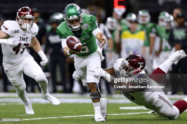 Trevon Sanders of the Troy Trojans forces a fumble on Mason Fine of the North Texas Mean Green during the first half of the R+L Carriers New Orleans...