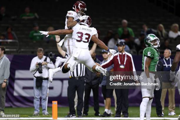 Damion Willis of the Troy Trojans celebrates a touchdown with Josh Anderson during the first half of the R+L Carriers New Orleans Bowl against the...