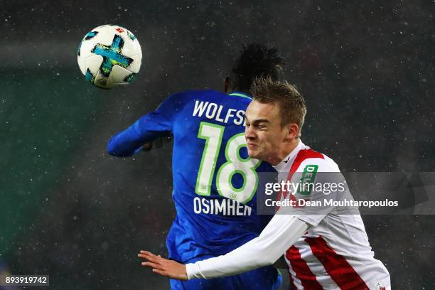 Victor Osimhen of Wolfsburg battles for the ball with Tim Handwerker of FC Koeln during the Bundesliga match between 1. FC Koeln and VfL Wolfsburg at...