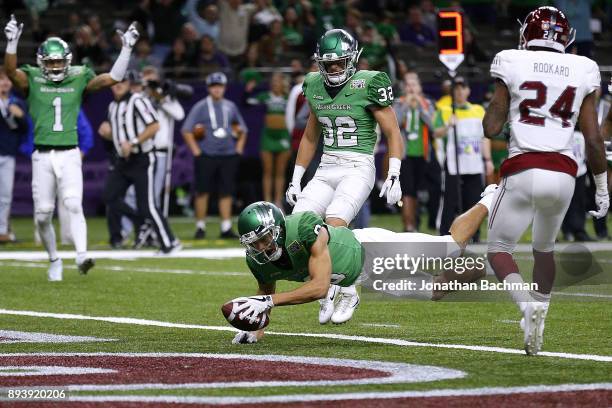 Rico Bussey Jr. #8 of the North Texas Mean Green dives for a touchdown during the first half of the R+L Carriers New Orleans Bowl against the Troy...