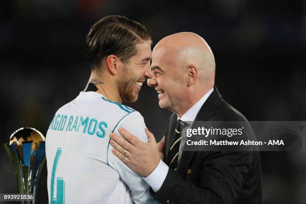 Sergio Ramos of Real Madrid receives his winners medal from FIFA President Gianni Infantino at the end of the FIFA Club World Cup UAE 2017 final...