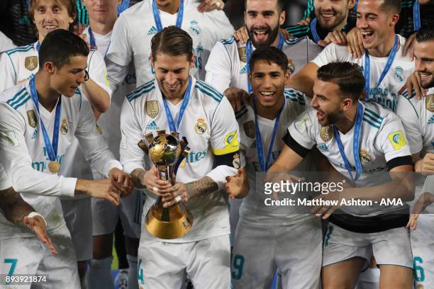 Sergio Ramos of Real Madrid prepares to lift the trophy with his team-mates at the end of the FIFA Club World Cup UAE 2017 final match between Gremio...