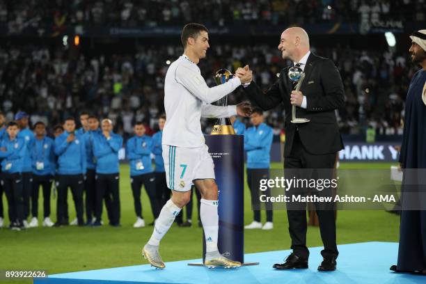 Cristiano Ronaldo of Real Madrid receives the adidas Golden Ball trophy from FIFA President Gianni Infantino at the end of the FIFA Club World Cup...