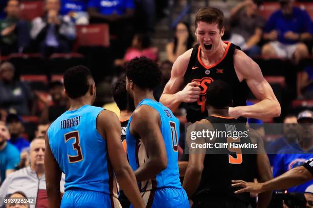 Mitchell Solomon of the Oklahoma State Cowboys celebrate with teammates in the finasl seconds of their 71 to 70 win over the Florida State Seminoles...