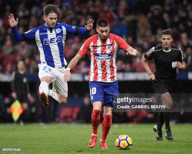 Atletico Madrid's Belgian midfielder Yannick Ferreira-Carrasco vies with Alaves' Spanish midfielder Alvaro Medran under the eye of Spanish referee...