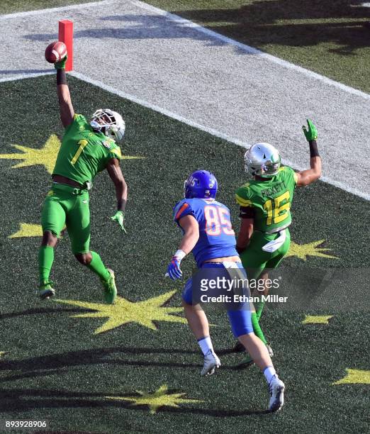 Cornerback Arrion Springs of the Oregon Ducks makes an interception in the end zone in front of tight end John Bates of the Boise State Broncos and...