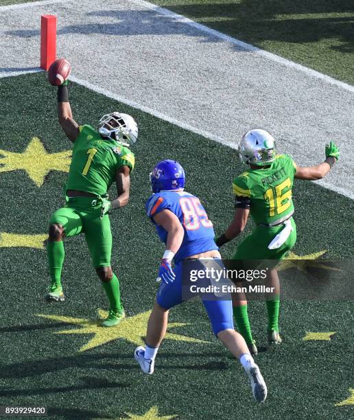 Cornerback Arrion Springs of the Oregon Ducks makes an interception in the end zone in front of tight end John Bates of the Boise State Broncos and...