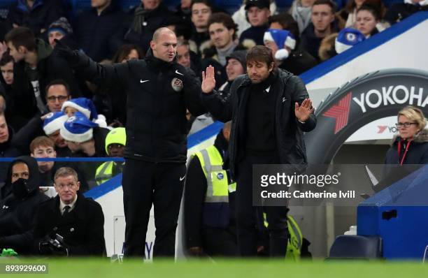 Antonio Conte manager / head coach of Chelsea puts his hands up as he talks to fourth official Bobby Madley during the Premier League match between...