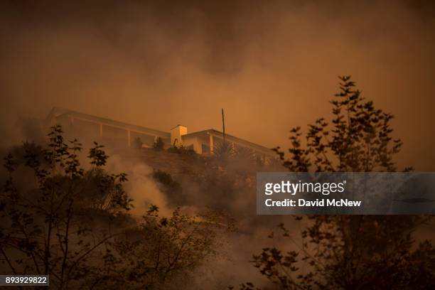 Fire passes between homes at the Thomas Fire on December 16, 2017 in Montecito, California. The National Weather Service has issued red flag warnings...