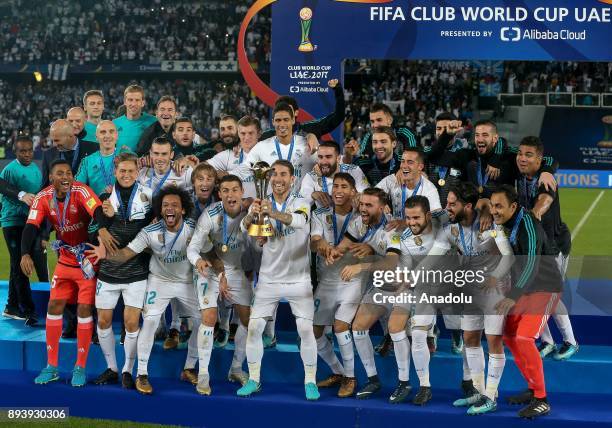 Players of Real Madrid celebrate with the trophy after the 2017 FIFA Club World Cup final match between Real Madrid and Gremio at the Zayed Sports...