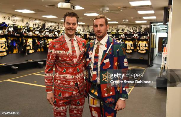 Tuukka Rask and Tim Schaller of the Boston Bruins wear festive holiday suits before the game against the New York Rangers at the TD Garden on...