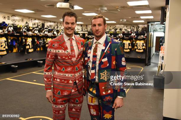 Tuukka Rask and Tim Schaller of the Boston Bruins wear festive holiday suits before the game against the New York Rangers at the TD Garden on...
