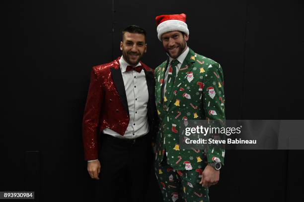 Patrice Bergeron and David Backes of the Boston Bruins wear festive holiday suits before the game against the New York Rangers at the TD Garden on...