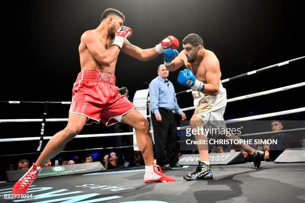 France's Tony Yoka fights against Belgium's Ali Baghouz during their heavy weight boxing bout, on December 16, 2017 in Boulogne-Billancourt. / AFP...