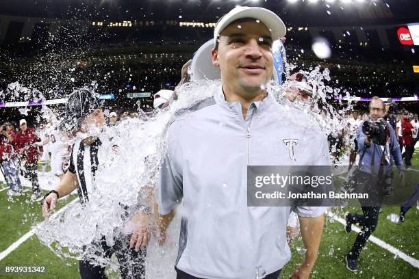 Head coach Neal Brown of the Troy Trojans is dunked with water after the R+L Carriers New Orleans Bowl against the North Texas Mean Green at the...