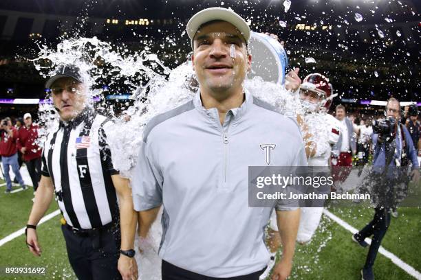 Head coach Neal Brown of the Troy Trojans is dunked with water after the R+L Carriers New Orleans Bowl against the North Texas Mean Green at the...