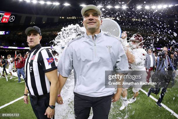 Head coach Neal Brown of the Troy Trojans is dunked with water after the R+L Carriers New Orleans Bowl against the North Texas Mean Green at the...