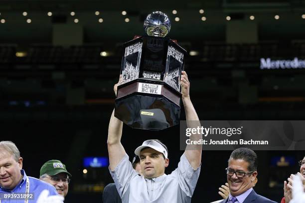 Head coach Neal Brown of the Troy Trojans celebrates with the trophy after the R+L Carriers New Orleans Bowl against the North Texas Mean Green at...