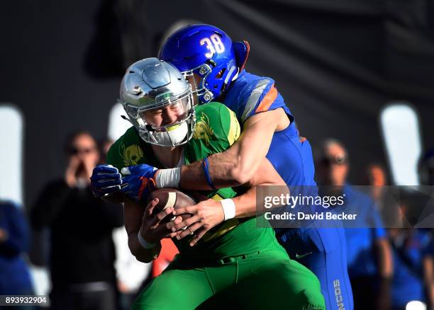 Quarterback Justin Herbert of the Oregon Ducks is sacked by Leighton Vander Esch of the Boise State Broncos during the first half of the Las Vegas...