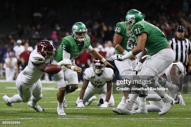 Sam Lebbie of the Troy Trojans forces a fumble on Mason Fine of the North Texas Mean Green during the second half of the the R+L Carriers New Orleans...