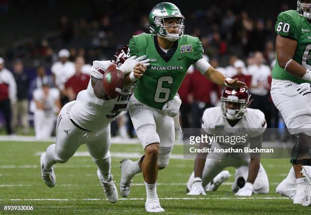 Sam Lebbie of the Troy Trojans forces a fumble on Mason Fine of the North Texas Mean Green during the second half of the the R+L Carriers New Orleans...