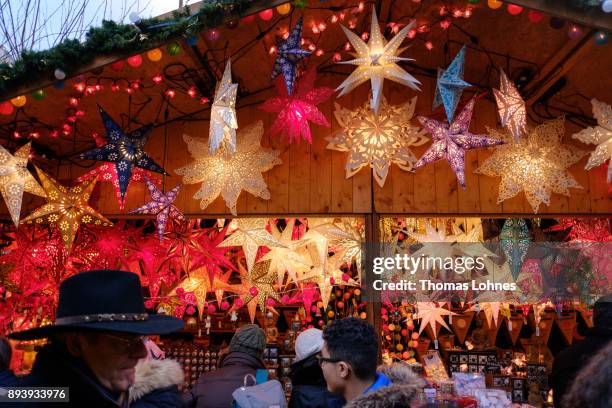 Visitors looks at a stall with Christmas decorations at the annual Christmas market at Roemerberg on December 16, 2017 in Frankfurt, Germany....