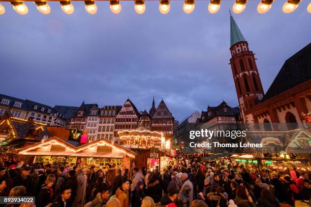 Visitors walk among stalls selling mulled wine, pastries, sausages, Christmas decorations, handicrafts and other Christmas delights at the annual...