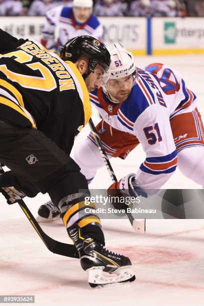 Patrice Bergeron of the Boston Bruins faces off against David Desharnais of the New York Rangers at the TD Garden on December 16, 2017 in Boston,...