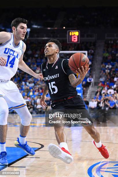 Cincinnati guard Cane Broome drives to the basket against UCLA forward Gyorgy Goloman during an college basketball game between the Cincinnati...