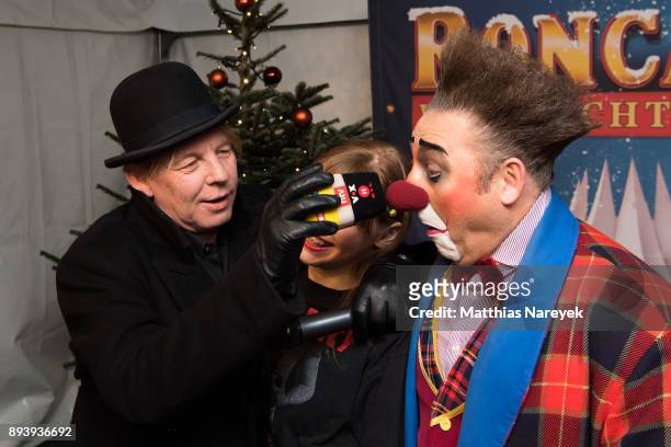 Ben Becker, his daughter Lilith Becker and a clown attend the 14th Roncalli Christmas at Tempodrom on December 16, 2017 in Berlin, Germany.