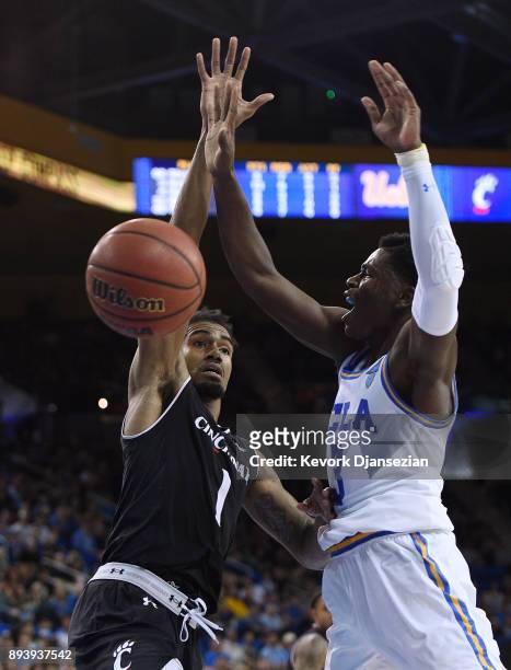 Aaron Holiday of the UCLA Bruins is fouled by Jacob Evans of the Cincinnati Bearcats during the second half at Pauley Pavilion on December 16, 2017...