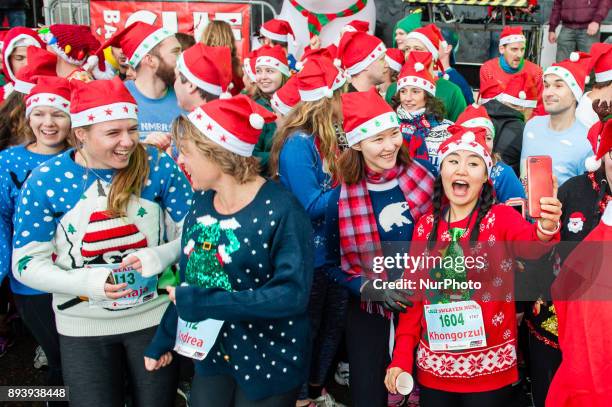 People take part in an Ugly Christmas Sweater Run on December 16, 2017 in The Vondelpark in Amsterdam, Netherland. During this 5K run, people have...