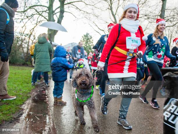People take part in an Ugly Christmas Sweater Run on December 16, 2017 in The Vondelpark in Amsterdam, Netherland. During this 5K run, people have...