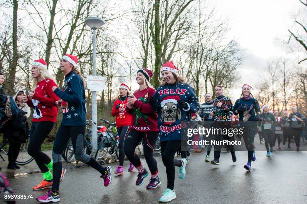 People take part in an Ugly Christmas Sweater Run on December 16, 2017 in The Vondelpark in Amsterdam, Netherland. During this 5K run, people have...