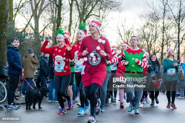 People take part in an Ugly Christmas Sweater Run on December 16, 2017 in The Vondelpark in Amsterdam, Netherland. During this 5K run, people have...