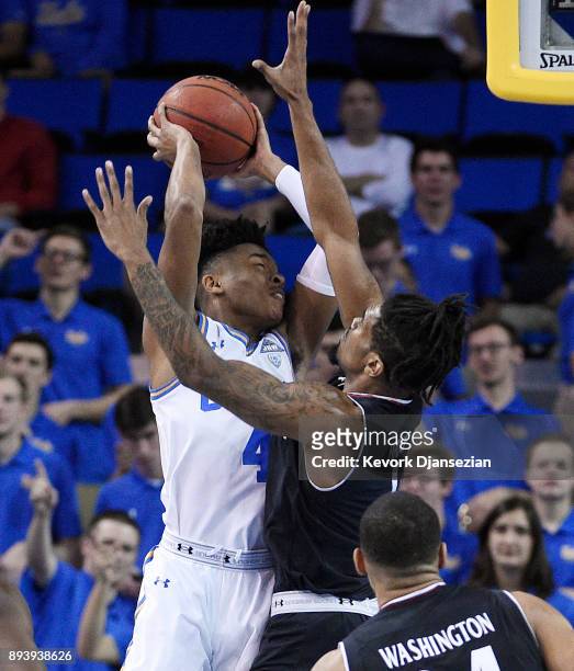 Jaylen Hands of the UCLA Bruins is defended by Jacob Evans of the Cincinnati Bearcats during the first half at Pauley Pavilion on December 16, 2017...