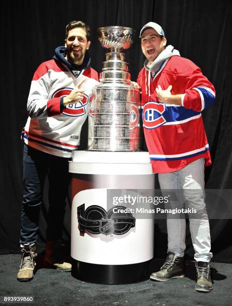 Fans pose with the Stanley cup in the Centennial Fan Arena during the 2017 Scotiabank NHL100 Classic at Lansdowne Park on December 16, 2017 in...