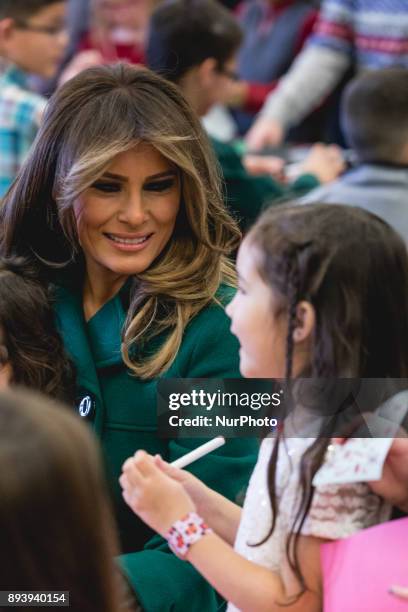 First Lady Melania Trump sits with military kids to make Christmas cards, at the Marine Corps' annual Toys for Tots event, at Joint Base...