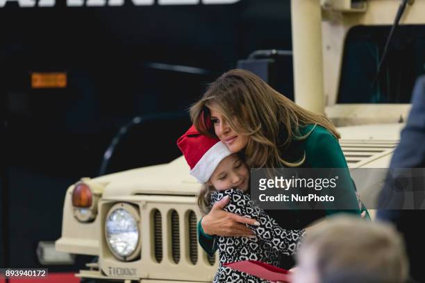 First Lady Melania Trump hugs a military kid at the Marine Corps' annual Toys for Tots event, at Joint Base Anacostia-Bolling in Washington, D.C., on...