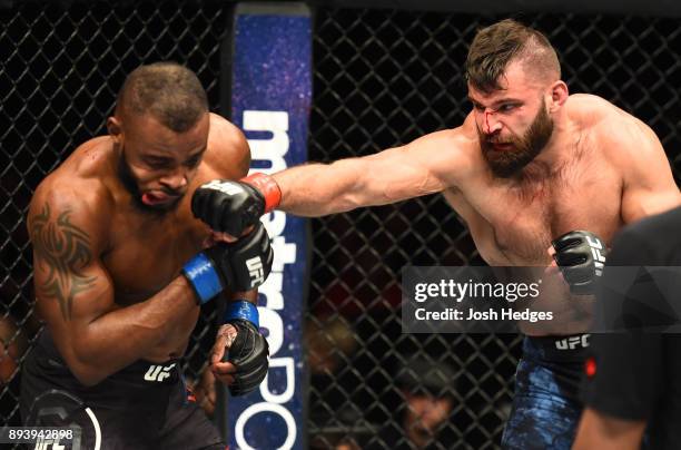 Julian Marquez punches Darren Stewart of England in their middleweight bout during the UFC Fight Night event at Bell MTS Place on December 16, 2017...