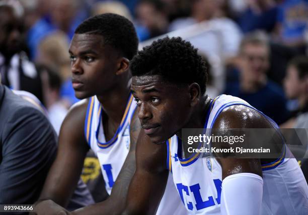 Aaron Holiday and Kris Wilkes of the UCLA Bruins follow the game from the bench during the second half against Cincinnati Bearcats at Pauley Pavilion...