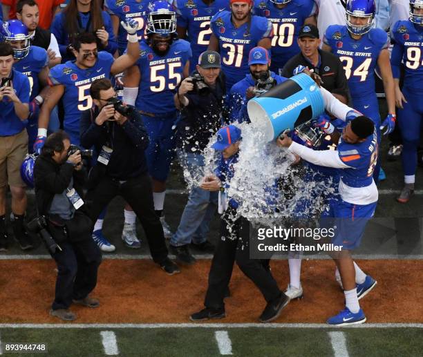 Tight end Chase Blakley of the Boise State Broncos helps dumps ice and water on head coach Bryan Harsin as time expires in their 38-28 victory over...