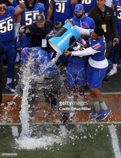 Tight end Chase Blakley of the Boise State Broncos helps dumps ice and water on head coach Bryan Harsin as time expires in their 38-28 victory over...