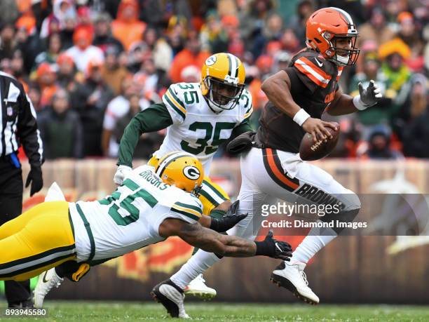 Quarterback DeShone Kizer of the Cleveland Browns carries the ball downfield as he breaks the tackle of linebacker Ahmad Brooks of the Green Bay...