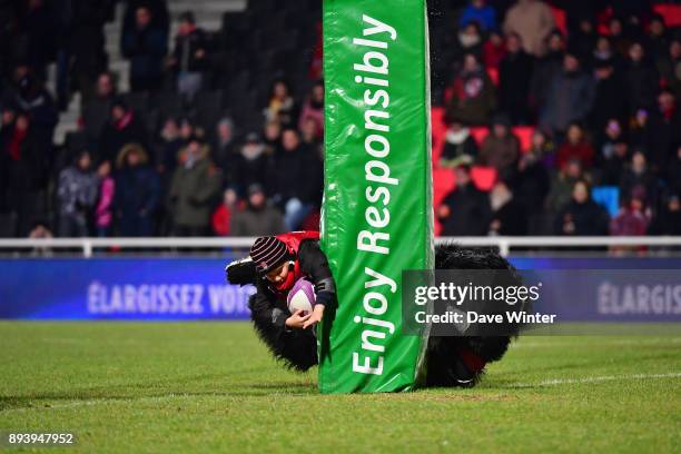 Half time entertainment sees children trying to score a try past the Lyon mascot during the European Rugby Challenge Cup match between Lyon OU and...