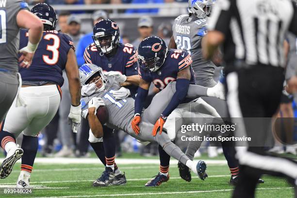 Detroit Lions wide receiver Marvin Jones Jr is tackled by Chicago Bears defensive back Prince Amukamara and defensive back Deon Bush during a game...