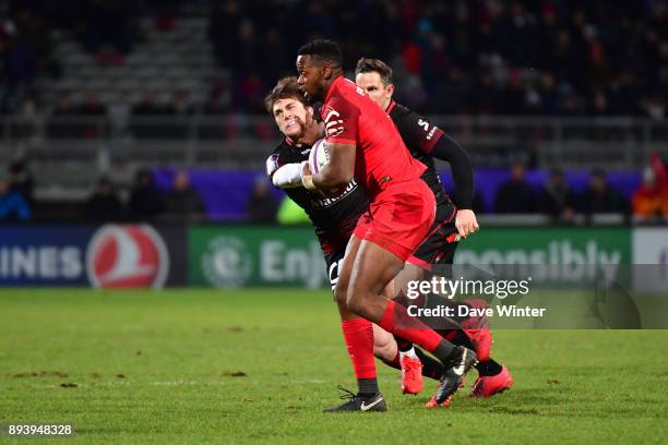 Wandie Mjekevu of Toulouse hands off Pierre Louis Barassi of Lyon during the European Rugby Challenge Cup match between Lyon OU and Stade Toulousain...