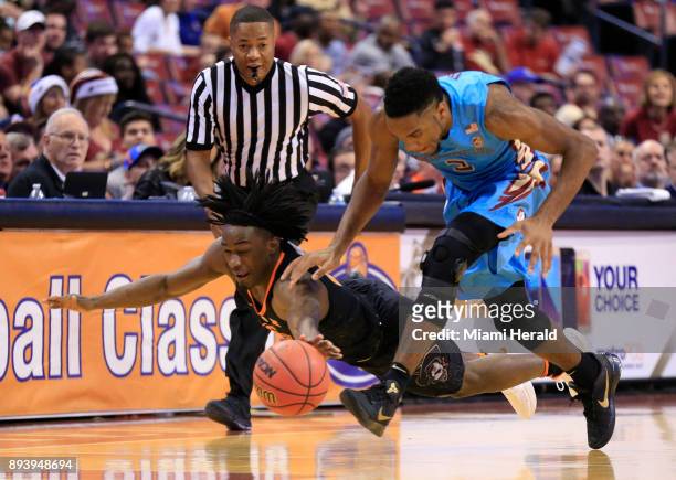 Florida State's Trent Forrest and Oklahoma State's Brandon Averette chase a loose ball in the first period during the Orange Bowl Basketball Classic...