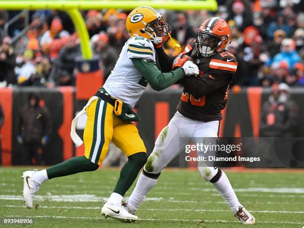 Running back Duke Johnson Jr. #29 of the Cleveland Browns stiff-arms safety Ha Ha Clinton-Dix of the Green Bay Packers, as he carries the ball...